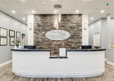White front reception desk with two hallway on each side 