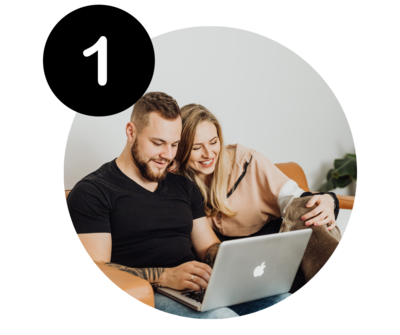 A man and woman looking at a laptop together.