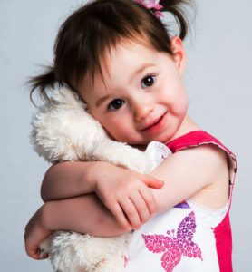 paediatric care - happy child hugging stuffed animal